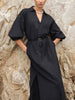 Woman wearing The Kate Maxi Dress in black, a belted button-down maxi dress with puff sleeves