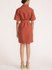 Back view of a woman wearing the Villa dress in Tuscany, a collared shirt dress paired with beige platform sandals.