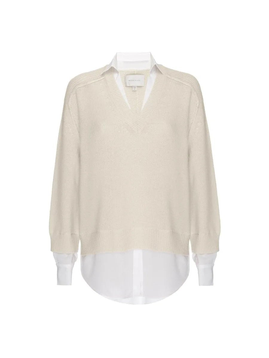 Almond v-neck layered sweater with attached white shirt collar, cuffs, and curved high-low hem.