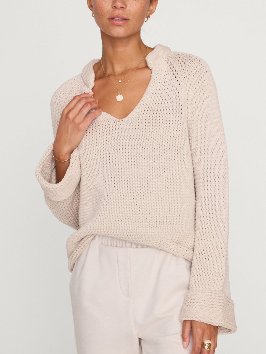 Aria stand collar deep v neckline beige sweater front view