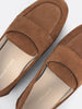 Close-up of tan suede loafers showing the branded leather insole detail.