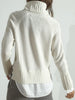 Back view of a white layered sweater with turtleneck, raglan sleeves, and satin shirttail hem.