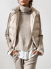 Beige layered turtleneck sweater styled with a cream puffer vest and white shirt underlayer.