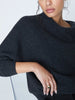 Close-up of charcoal ribbed cashmere sweater with angled cowl neck panel and relaxed fit.