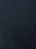 Close-up of dark charcoal ribbed knit fabric showing the cashmere sweater's multi-directional rib stitch texture.