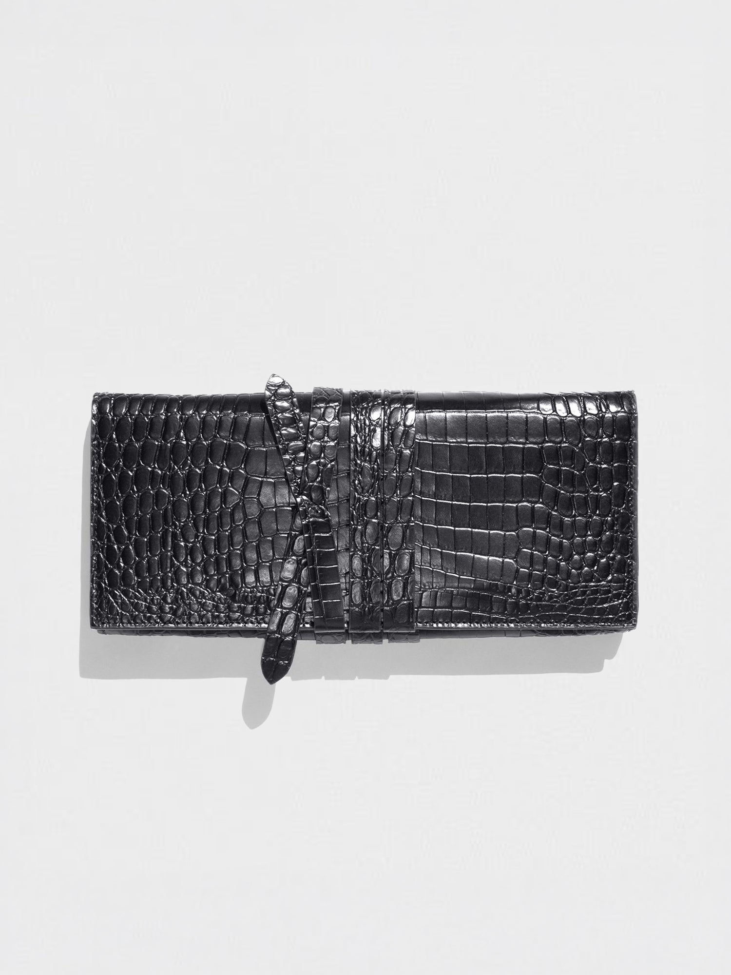 Black crocodile-embossed clutch wallet with a wrap-around strap closure