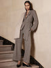 Croco-embossed black mary-jane loafers, styled with a taupe wrap blazer and wide-leg trouser suit