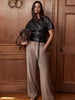 Duke beige wide-leg trousers, styled with a black faux-leather top and brown handbag