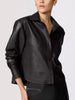 Cropped vegan leather shirt jacket in black, close-up studio shot