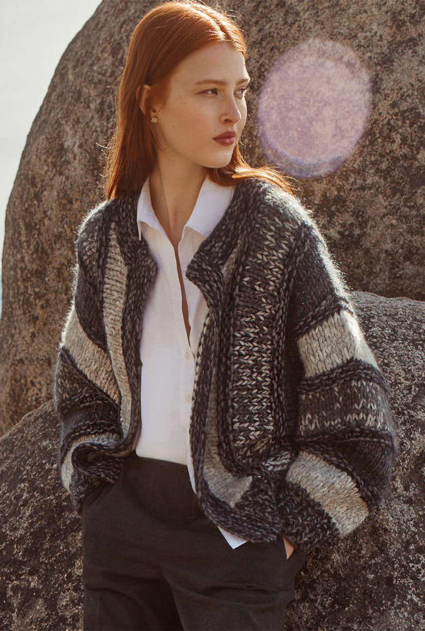 model standing in front of a rock wearing brochu's cardigan