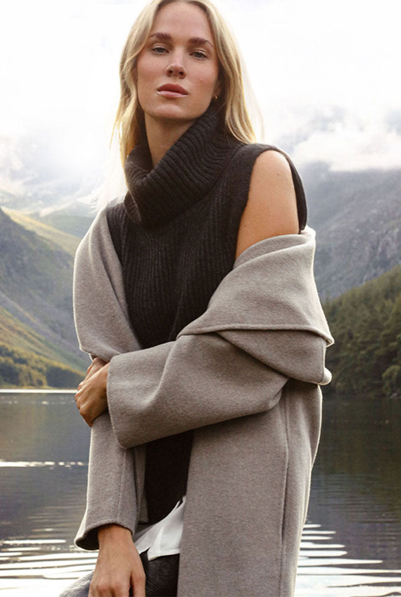 model standing in front of a lake wearing a brochu coat