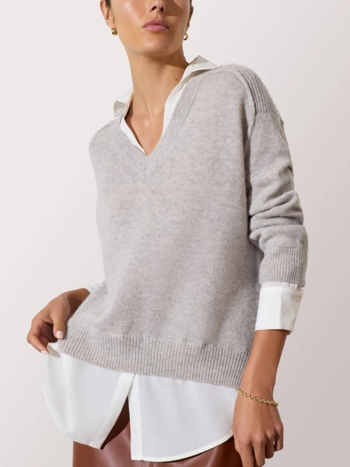 Light grey layered sweater with V-neck and white shirt collar, cuffs, and curved high-low hem.