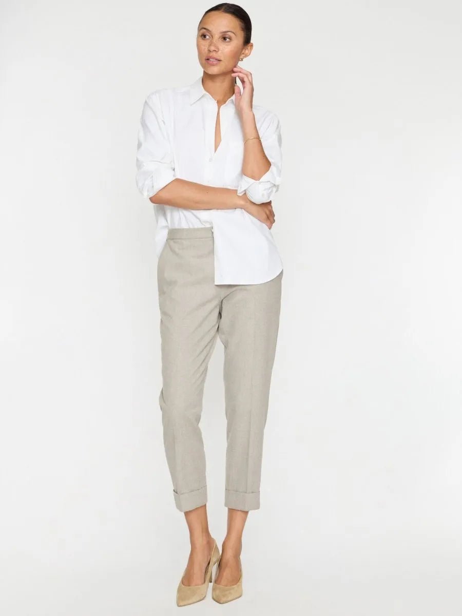 Model wearing Westport brushed pull-on pants in whisper melange beige with cuffed ankles, styled with a white shirt and tan.