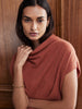 Woman wearing the Morten women's cashmere sweater in rust with cowl neck