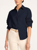 Button-down shirt in navy, styled with rolled sleeves and cream trousers
