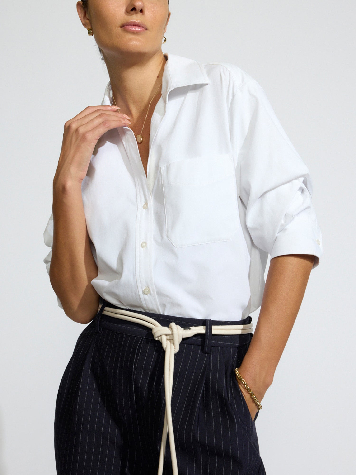 Women's Pia white button-up shirt with rolled sleeves and pinstripe trousers
