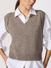 Close-up of a taupe V-neck knit sweater vest layered over a white collared shirt.