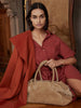 Shirt dress in rust red, seated with a tan suede tote bag