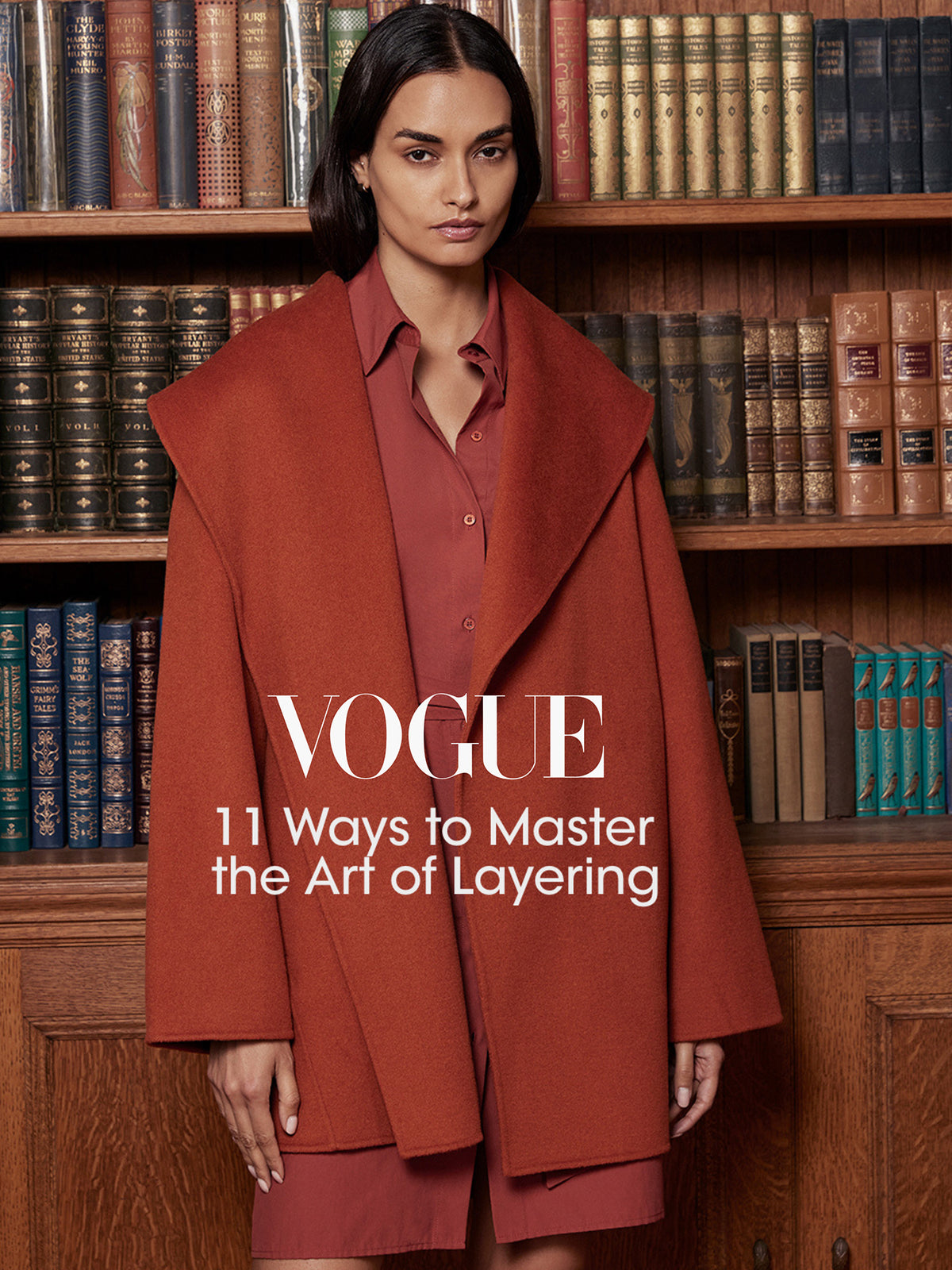 Woman wearing a rust-orange wool wrap coat, featured in a Vogue layering feature graphic